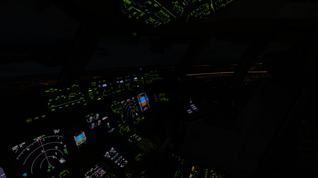 the cockpit of a B777 lit up at night